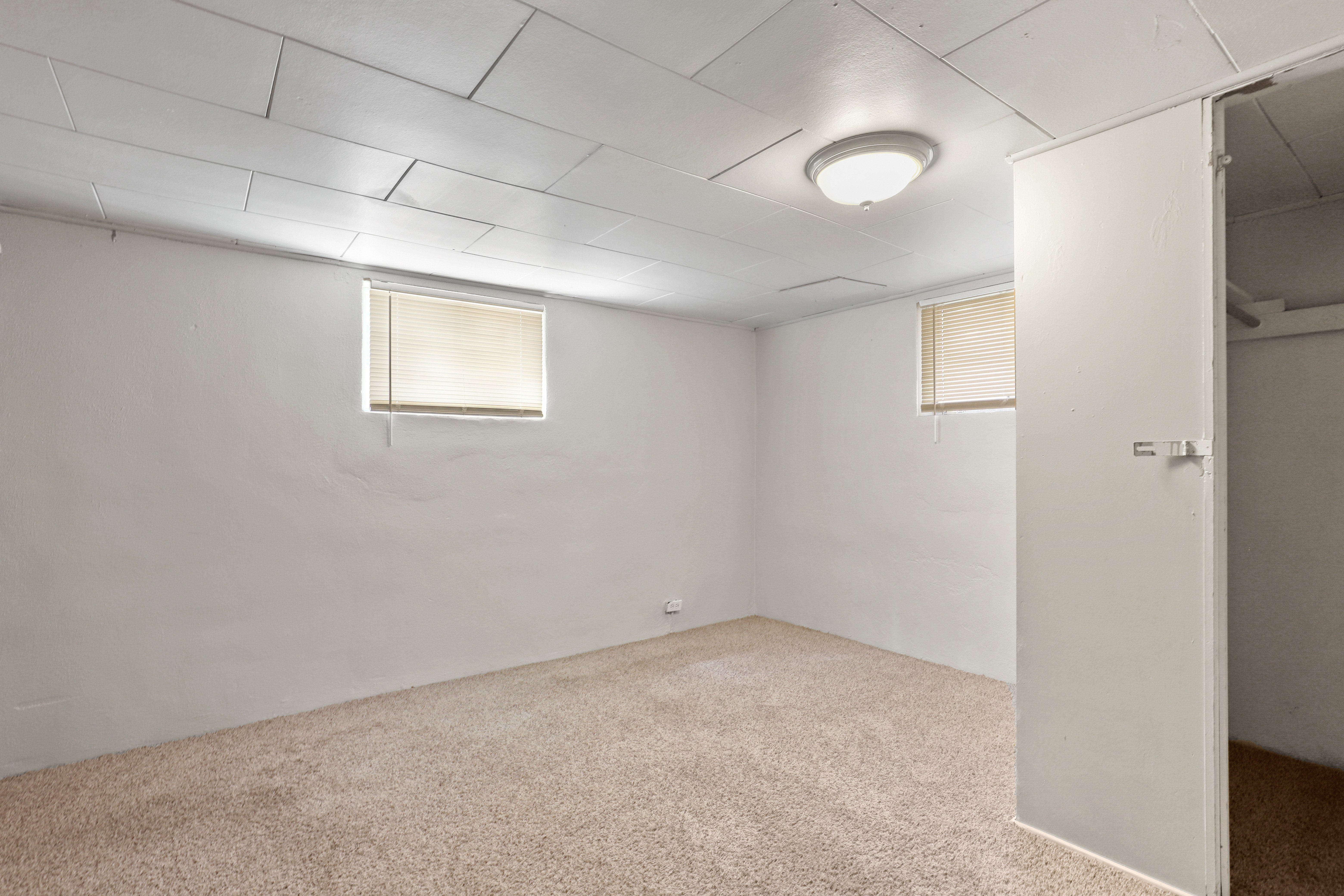 the interior of an empty room with a door and a window